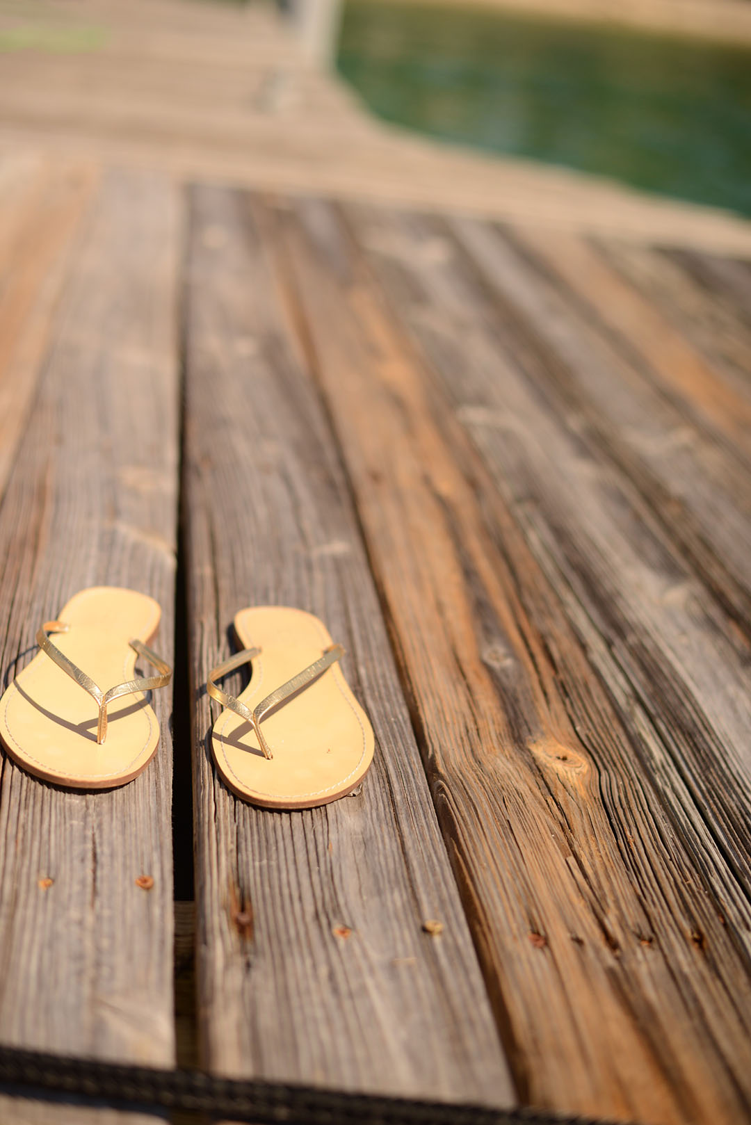 j.crew flip flops on a pier photographed by sara delaney