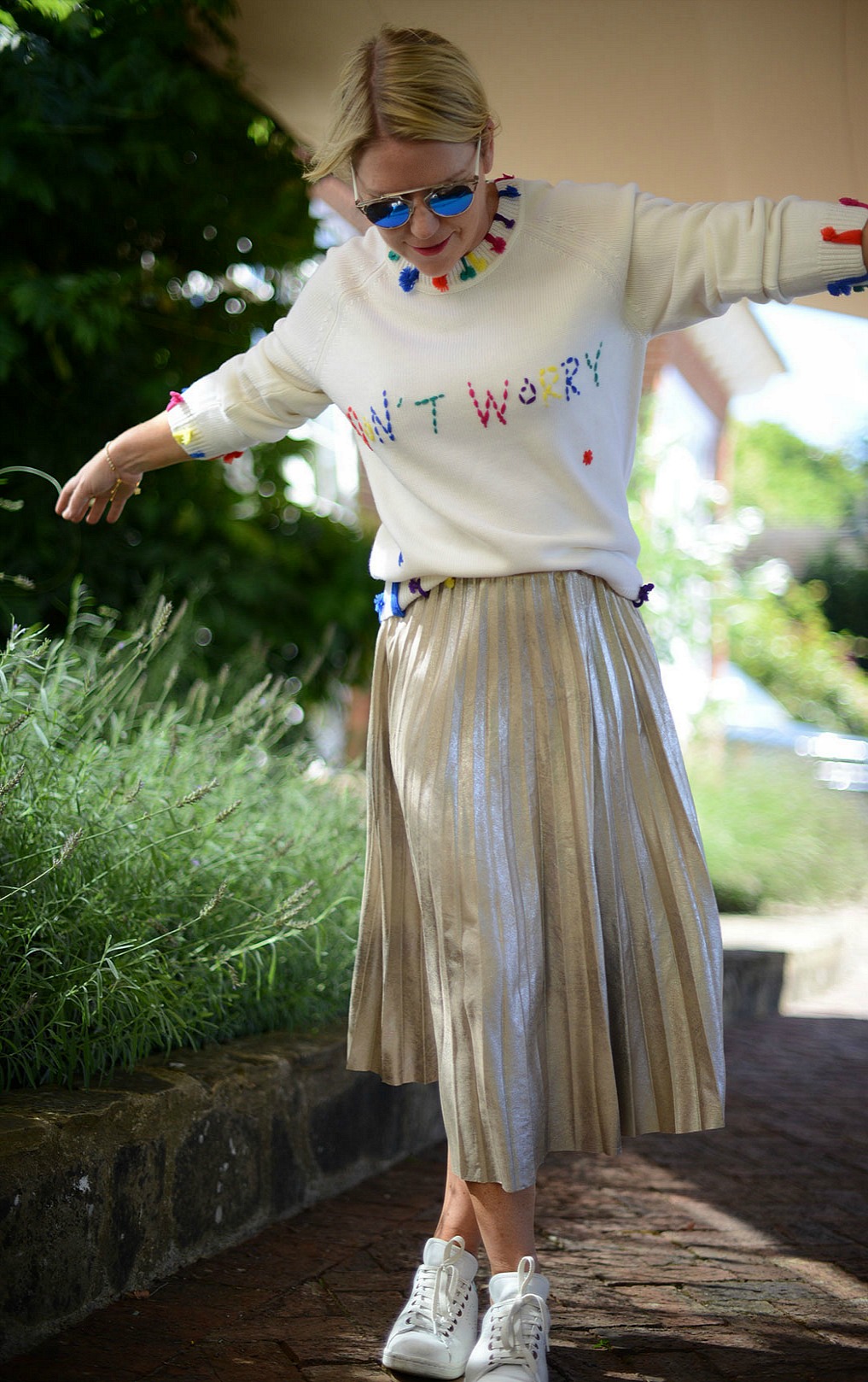pleated skirt from zara and statement knit by mira mikati worn by stylist and blogger sara delaney
